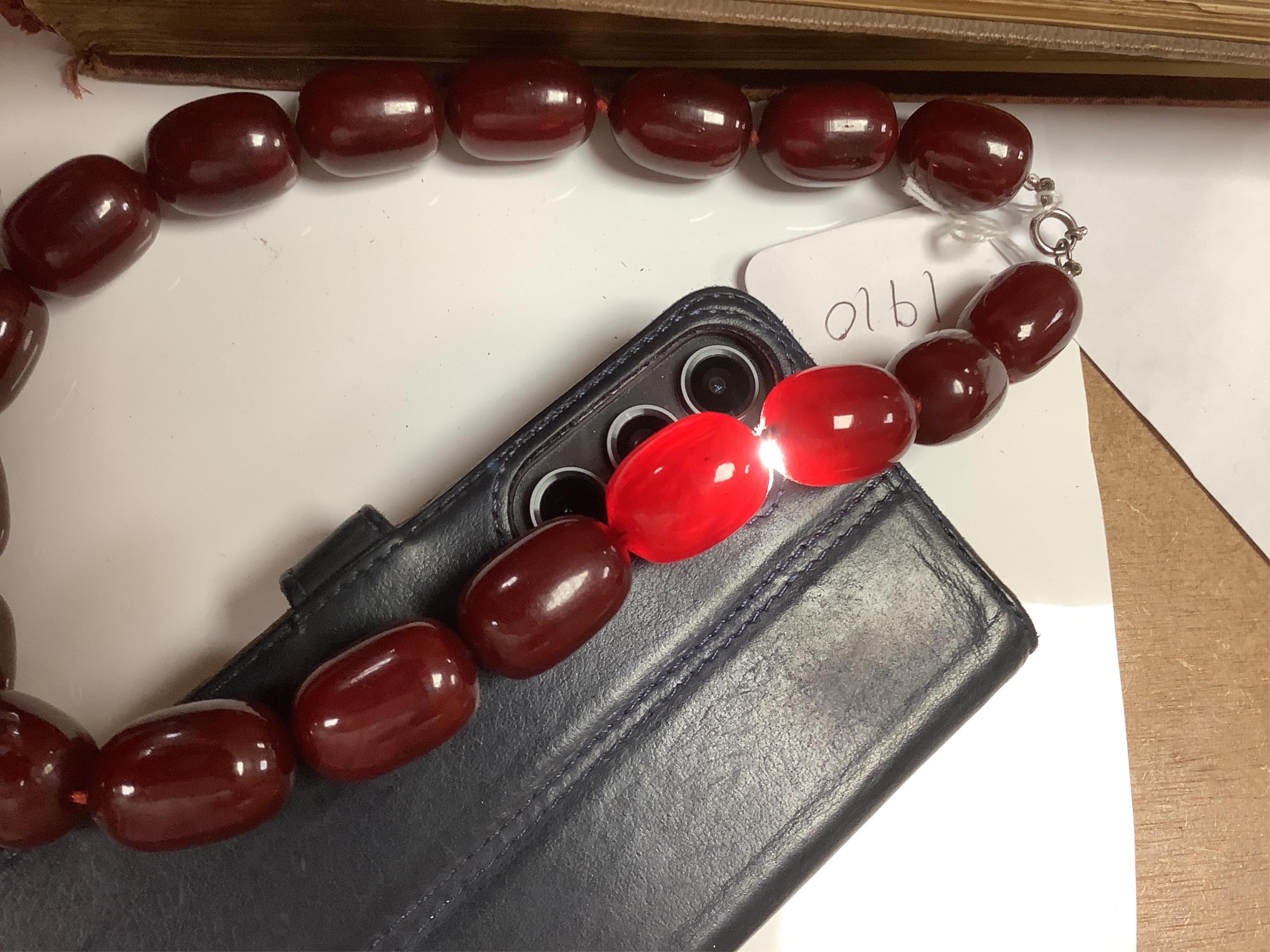 A single strand simulated cherry amber oval bead necklace, 48cm, gross weight 120 grams. Condition - fair